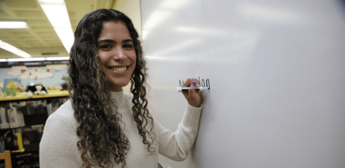 Elementary Education student writing on a white board