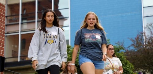 Students walking around Mansfield's campus during orientation