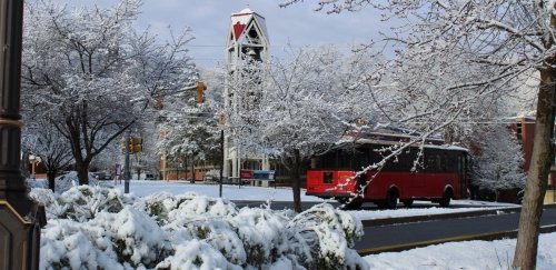 The Lock Haven Bell Tower with a trolley driving by