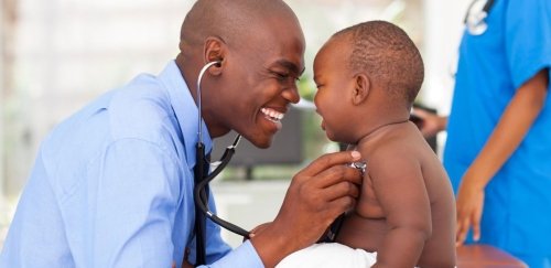 Doctor using stethoscope on baby.