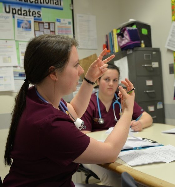 nursing students discussing clinical information in a classroom setting