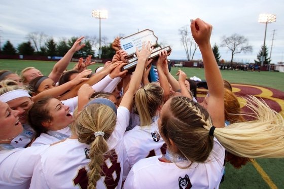 A team huddling with their award. 