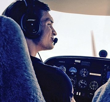 Adam Campbell in the cockpit of a plane