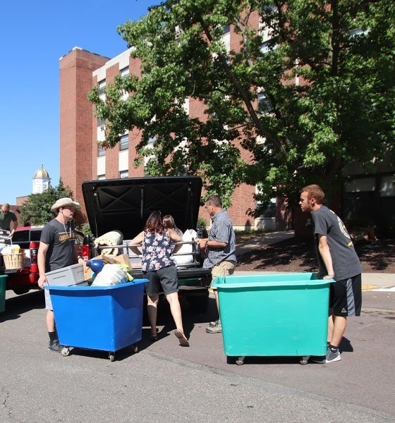 Students and parents use carts to unload vehicles during move-in at Commonwealth University - Bloomsburg