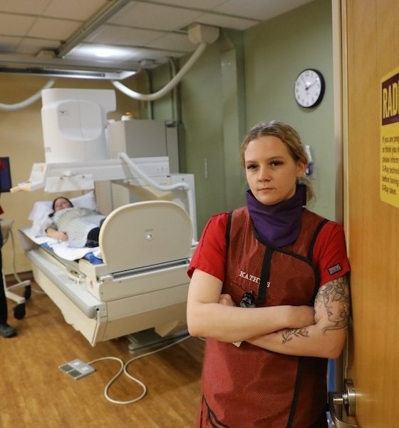 Radiologic Technology student standing in lab with arms crossed