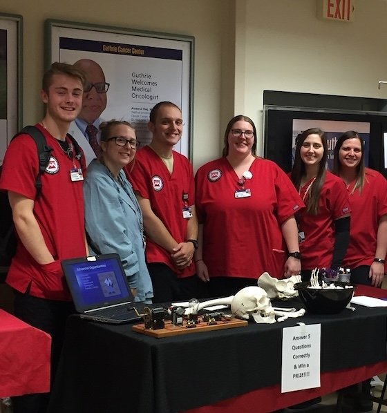 Radiologic Technology students standing behind display table