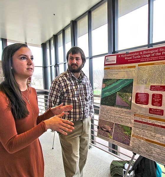 Student presenting research poster