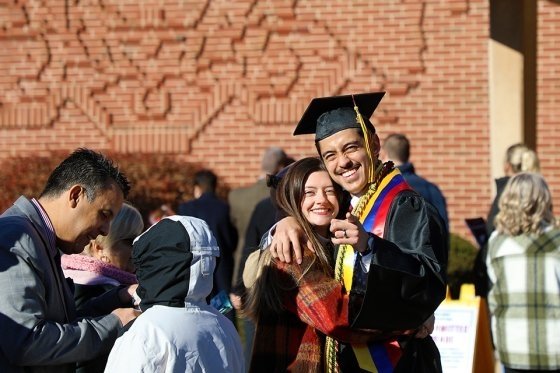 Graduate students posing following a commencement ceremony