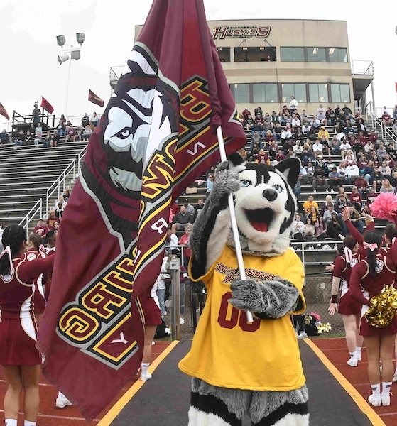 Bloomsburg mascot holding flag at football game