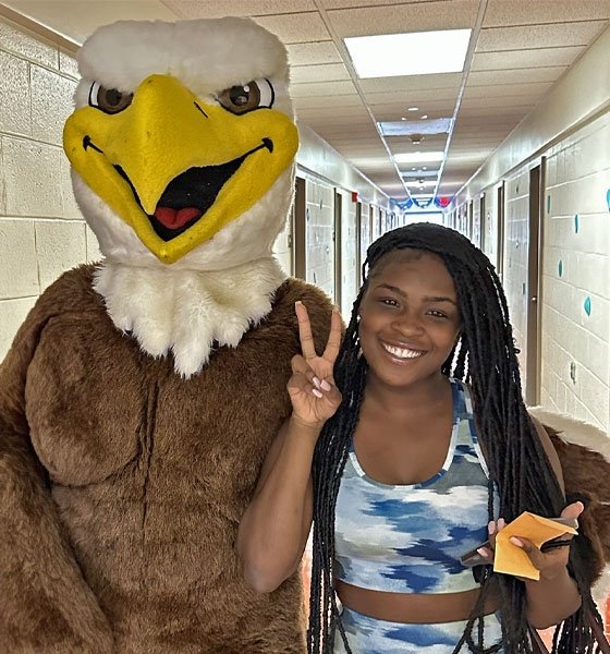 CU- Lock Haven student poses with Bald Eagle mascot, Talon