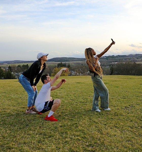 Friends gather for a selfie on the new greenspace at Commonwealth University-Mansfield, formerly Mansfield University