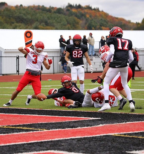 Quarterback stretches for a touchdown during Homecoming at Commonwealth University-Mansfield, formerly Mansfield University.