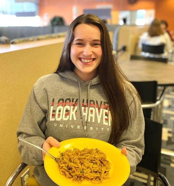 Female student holding plate of food at CU-Lock Haven