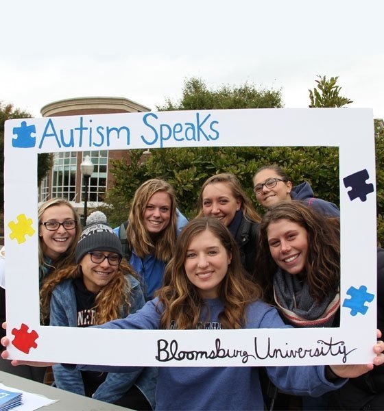 Students holding sign - Autism Speaks at Bloomsburg University