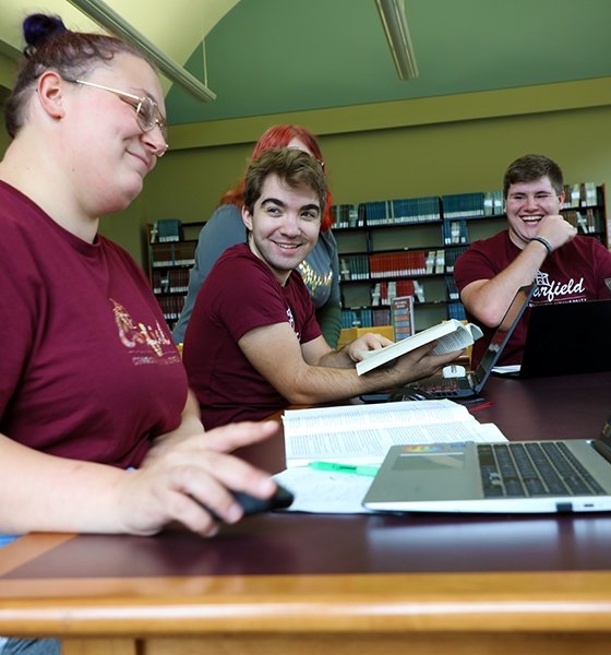 Students joke during a study session at the library at Commonwealth University-Clearfield, formerly Clearfield University.