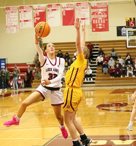 Women's basketball player takes a contested shot in the lane at Commonwealth University-Lock Haven, formerly Lock Haven University.