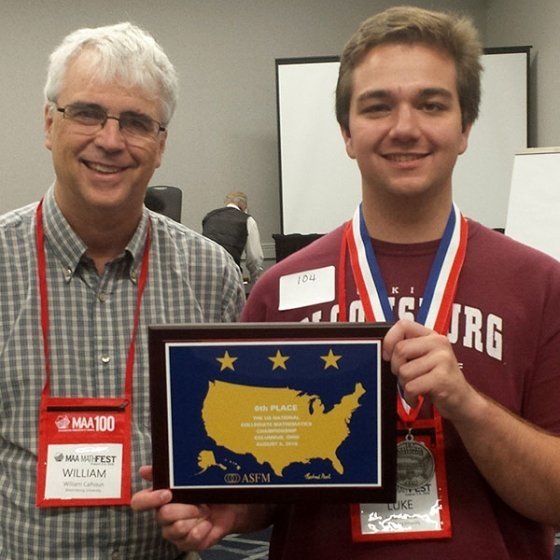 Luke Vuksta shows award from math competition.