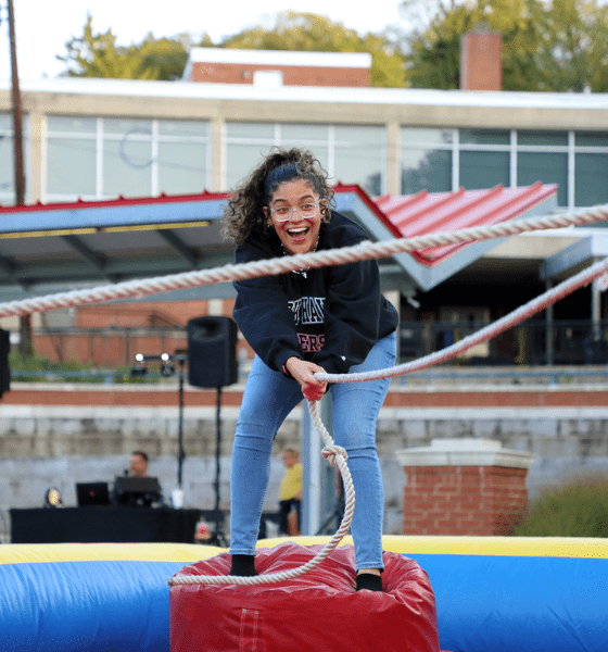 Lock Haven student using a rope over obstacle course