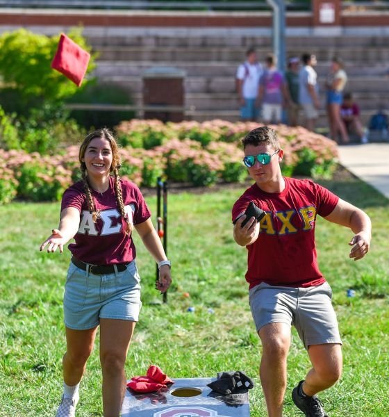 Commonwealth University-Lock Haven, formerly Lock Haven University, greek life students play cornhole on campus with fraternity and sorority letters