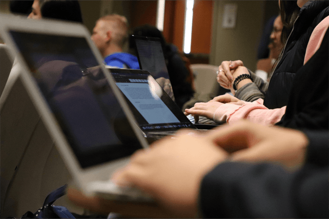 A closeup of people working on computers. 