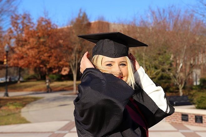 Student in graduation robe.