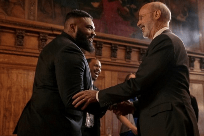 Former Governor of Pennsylvania Tom Wolf Shaking Hands with Bloomsburg student