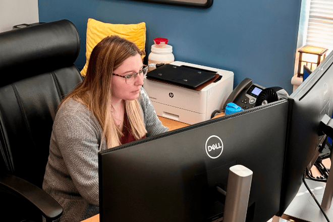 M.S. Information Technology student sitting behind a computer