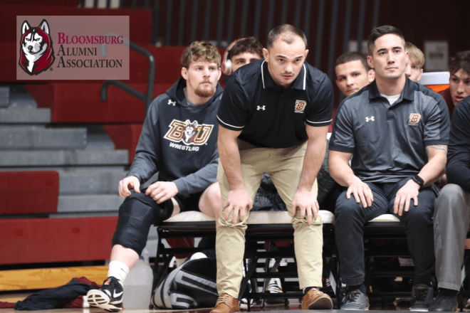 Photo of a Bloomsburg Wrestling coach watching a match from the sideline