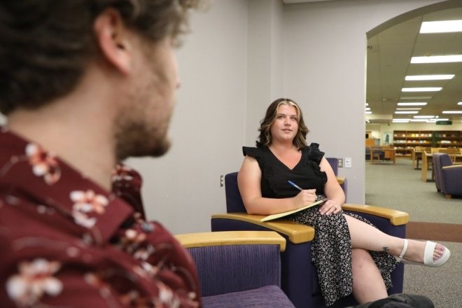 A CU MSW student talking to a fellow student in the Andruss Library at CU-Bloomsburg