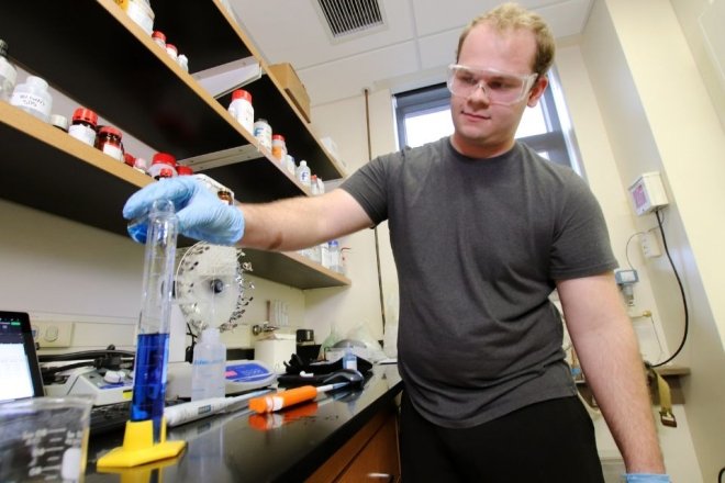 A Chemistry student conducing an experiment in a lab at CU-Lock Haven