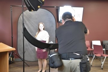 A man taking a photo of a woman. 