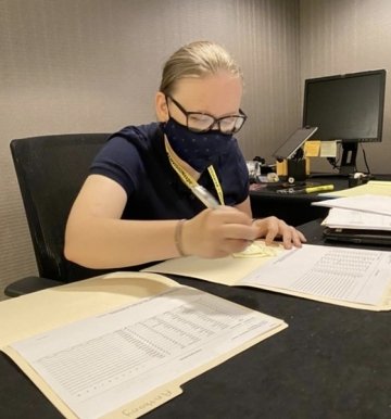 A girl working on some papers. 