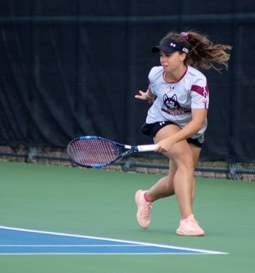 A girl playing tennis. 