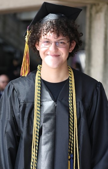 A man in a graduation gown and cap.