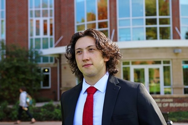 A picture of a guy outside of a building. 