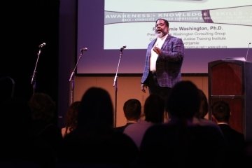 A guy speaking on stage. 