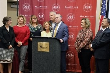 A group standing behind a podium.