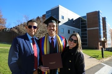 Three people standing next to each other. 