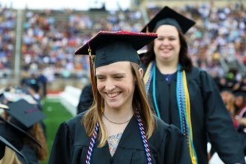 A girl walking at graduation.