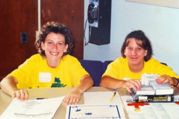 Two girls sitting at a table. 