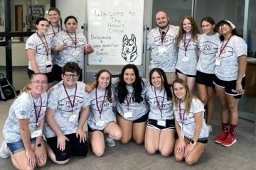 A group photo with a whiteboard. 