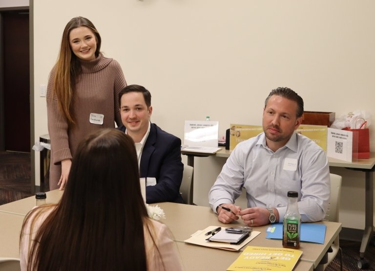 The couple pictured standing with two interviewers at the Boot Camp. 