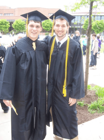 Two men standing together on graduation day.