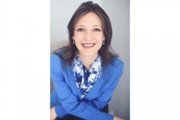 A headshot of a woman. 