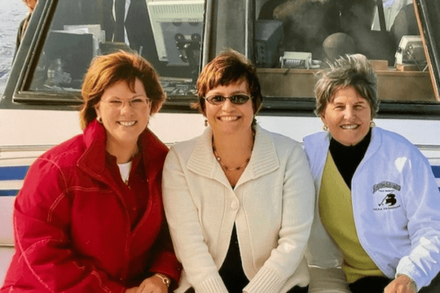 A group of three sitting on a boat. 