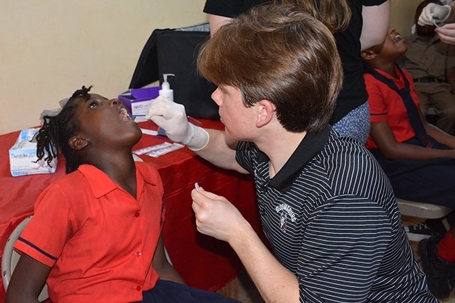 A man helping a child. 