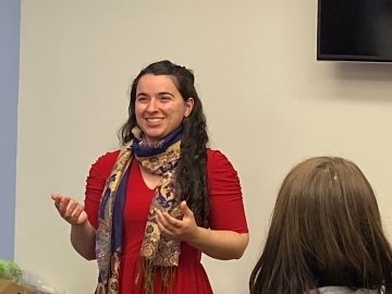 A girl talking to a group. 