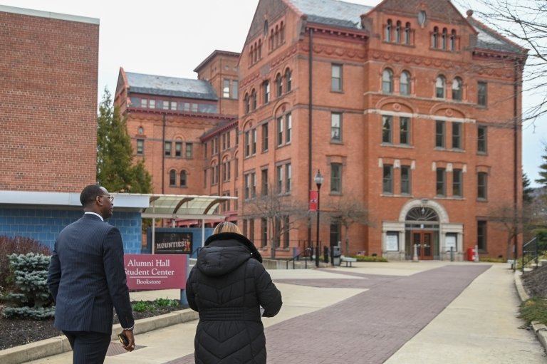 Two people walking through campus. 