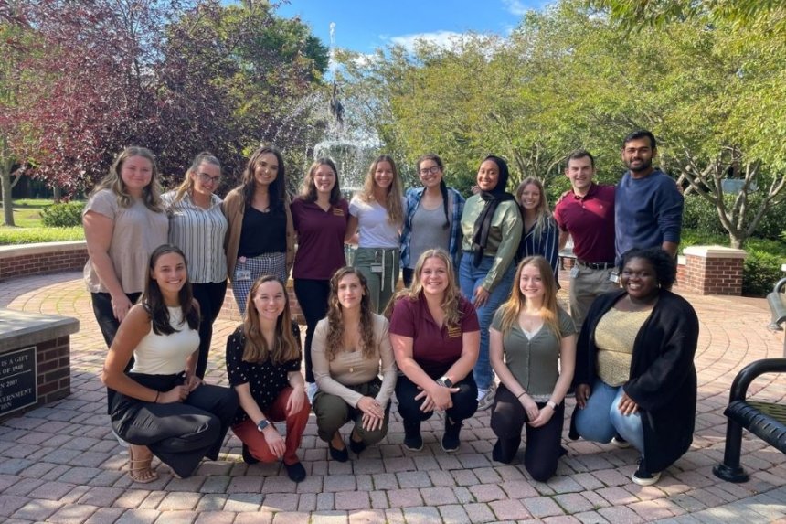 AuD Audiology students posing for a photo in front of a fountain