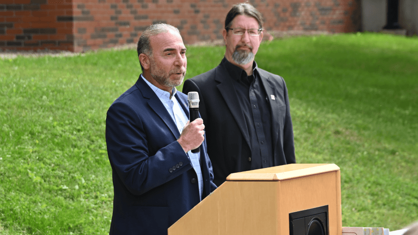 Bashar Hanna giving a speech with John Ulrich. 